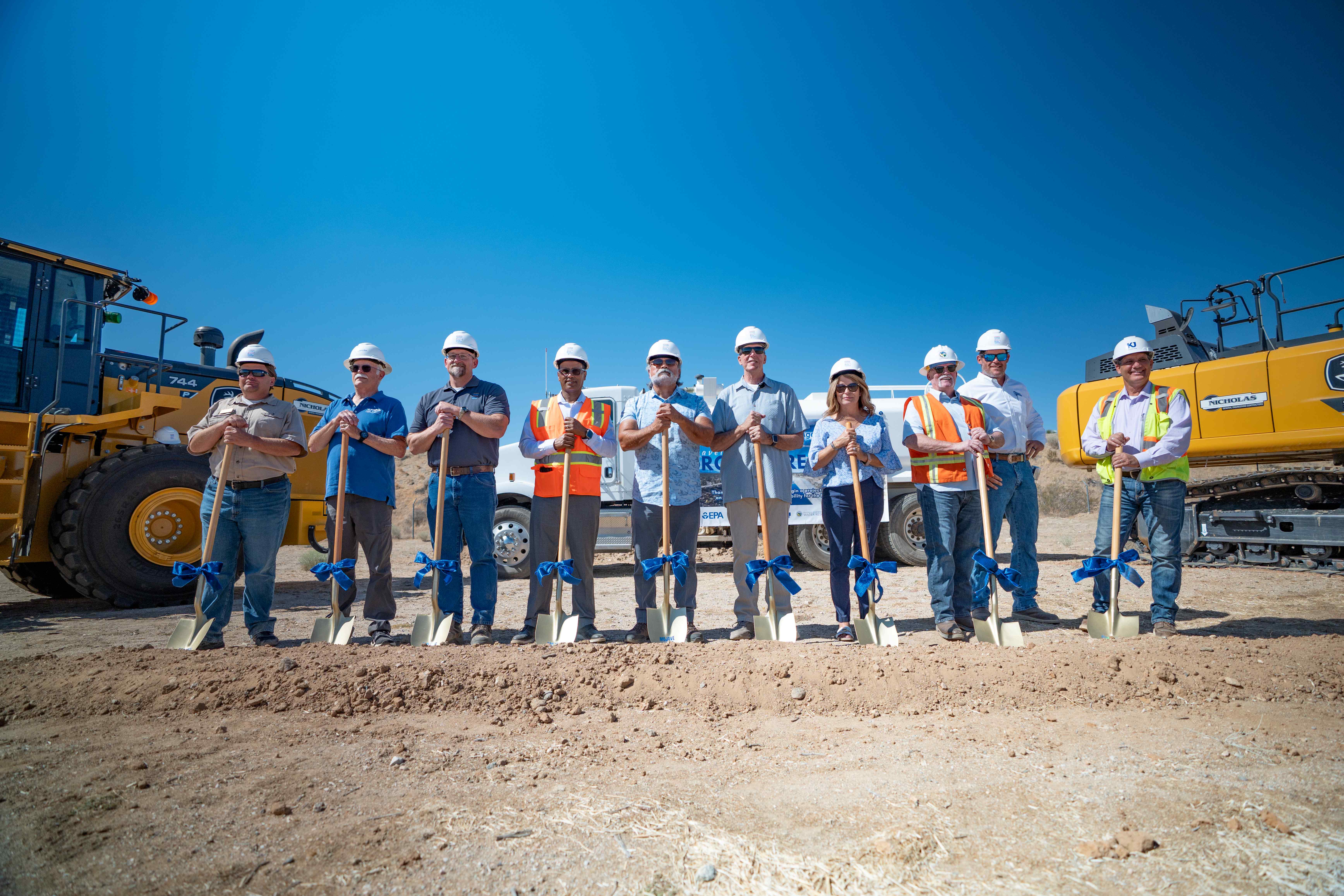 Officials with golden shovels at groundbreaking event.